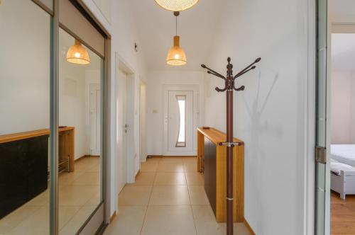 a hallway with a room with a bed and a glass door at Casa Tatjana in Rošini