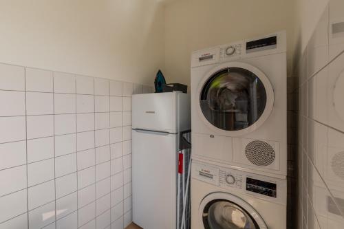 a kitchen with a washing machine and a washer at Casa Tatjana in Rošini