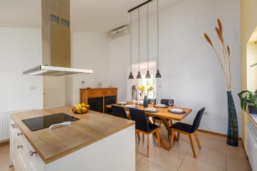 a kitchen with a table with chairs and a dining room at Casa Tatjana in Rošini