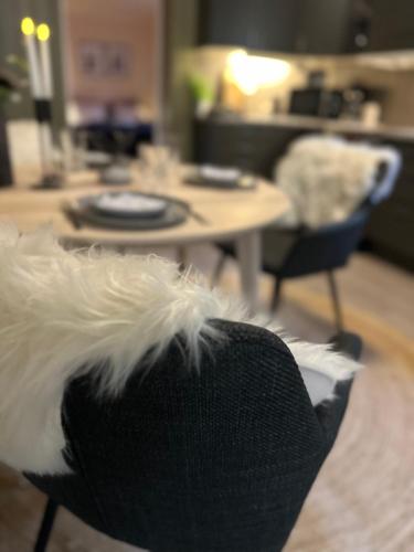 a black and white chair in a room with a table at Lofoten Retreat Apartment in Leknes