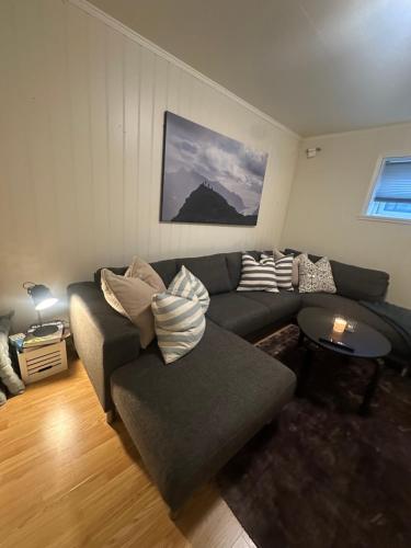 a living room with a couch and a table at Lofoten Retreat Apartment in Leknes