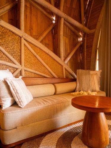 a living room with a couch and a table at Ulaman Eco Luxury Resort in Tabanan