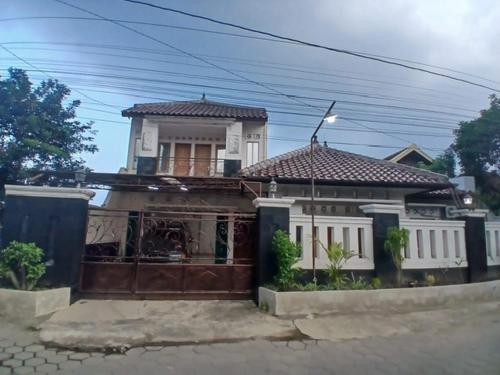 a house with a gate in front of it at Podhomoro homestay in Kalasan