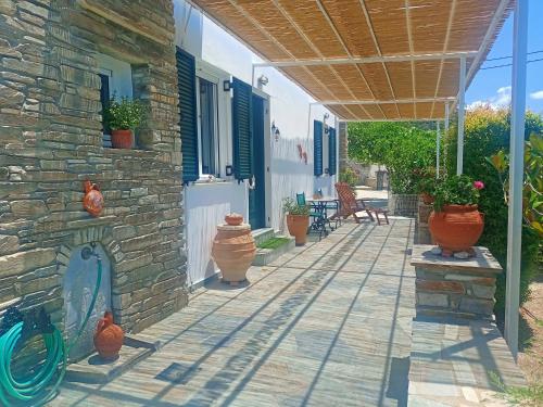 a patio with vases on the side of a house at Efi's apartment in Apróvaton