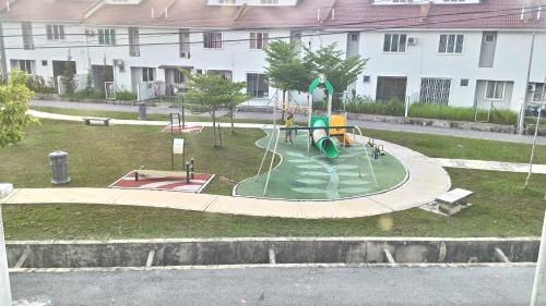 a park with a playground in the middle of a building at Dillenia Nilai Homestay in Nilai