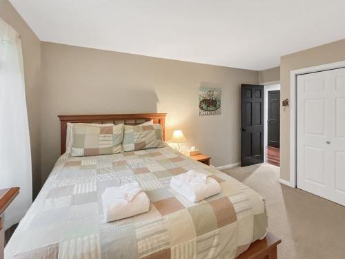 a bedroom with a large bed with towels on it at Sugar Hollow home in Chittenden