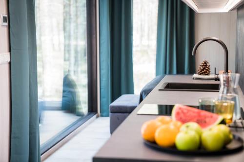a plate of fruit on a counter in a kitchen at Rahusalu Calm in Laulasmaa
