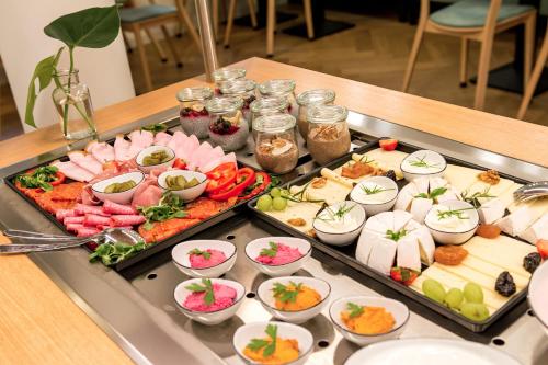 a buffet with many different types of food on a table at Alte Bäckerei Königstein Aparthotel und Café in Königstein an der Elbe