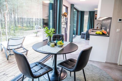 a kitchen and dining room with a table and chairs at Rahusalu Calm in Laulasmaa