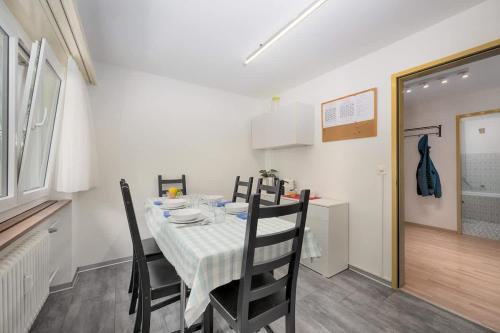 a dining room with a table and some chairs at Breithorn View in Täsch