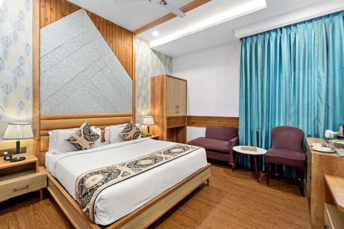 a hotel room with a bed and a desk at PRIME LAND in Varanasi