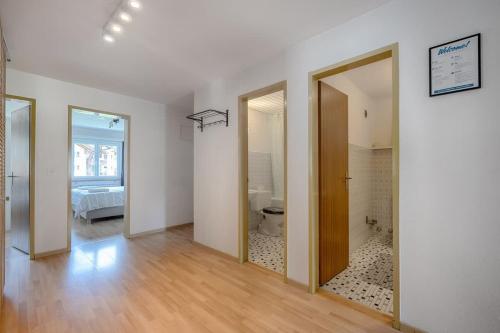 a room with a bathroom with a toilet and a bedroom at Breithorn View in Täsch