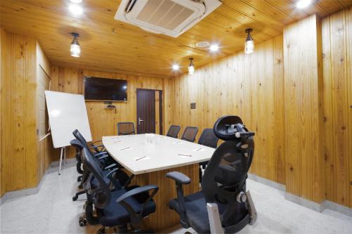 a conference room with a white table and chairs at PRIME LAND in Varanasi