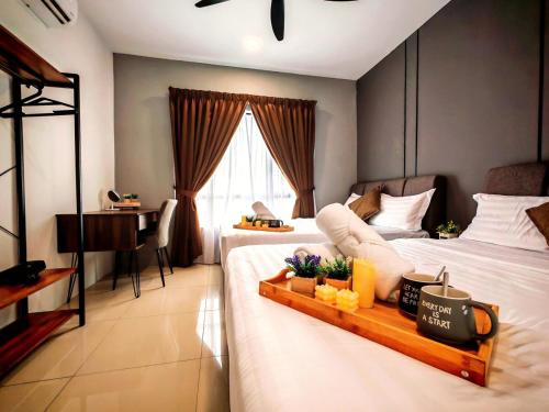 a bedroom with two beds with a desk and a table at Ipoh Manhattan Waterpark 3BR Suite by City Home Empire MHB509 in Ipoh