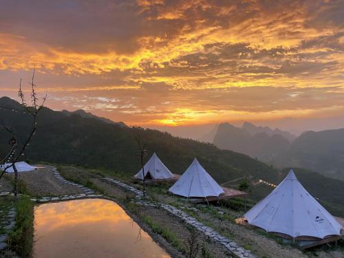 a group of tents on top of a mountain at Sunrise Ha Giang Camping An Introspective Stay in Suy Tung Su