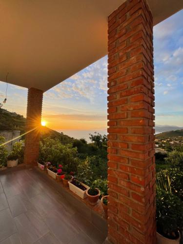 a view of a sunset from the balcony of a house at Grand Seaview Apartments in Ksamil