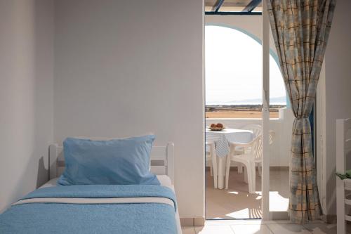 a bedroom with a bed and a view of the ocean at Aurea Blu Studio 10 Dreaming, beach, tranquility, sea in Aliko Beach