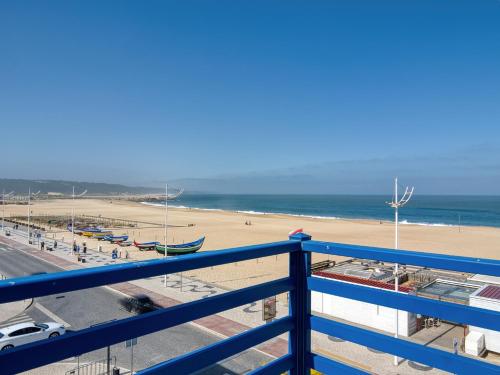 a view of the beach from a balcony at Sea View Apartment in Nazaré