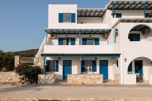 a white house with blue doors at Aurea Blu Studio 10 Dreaming, beach, tranquility, sea in Aliko Beach
