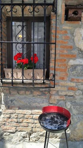 a red chair sitting in front of a window at La Casina de la Caleyona, Parres - Llanes in Llanes
