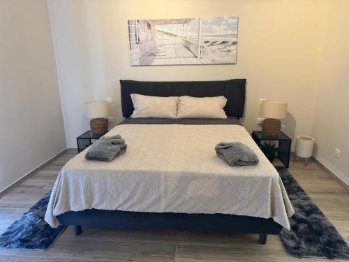 a bedroom with a bed with two towels on it at Wardija Heights Luxury Penthouse in Qala