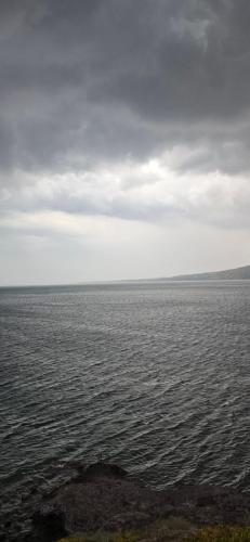 a large body of water with a cloudy sky at Ithaca in Perdhika