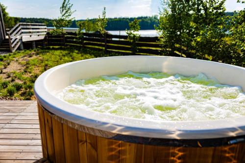 a bath tub filled with water on a wooden deck at Monialuki in Nogat