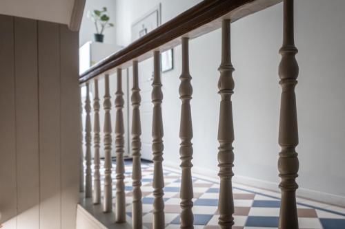 a staircase with wooden railings and a blue and white tile floor at Polpo Apartments B&B in Łódź