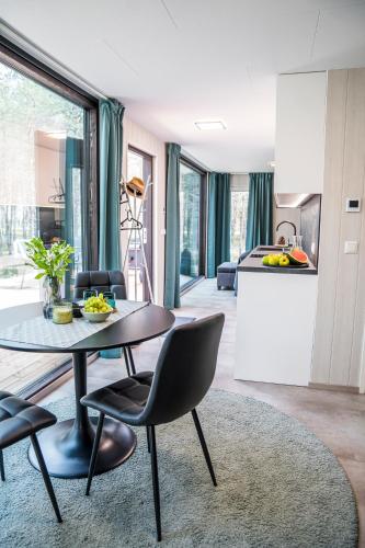 a kitchen and living room with a table and chairs at Rahusalu Calm in Laulasmaa