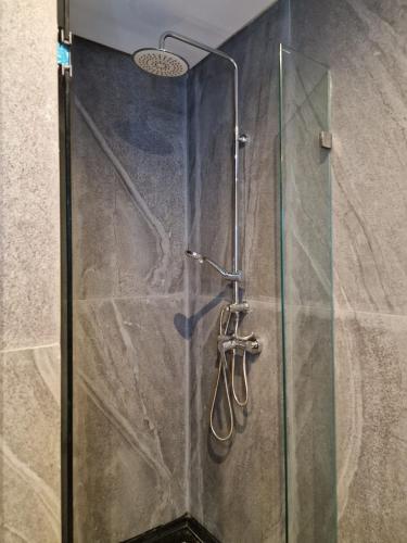 a shower with a glass door in a bathroom at Bella Vista MEHDIA in Kenitra
