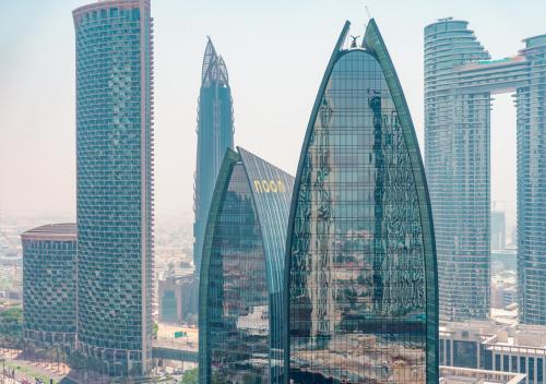 a group of tall buildings in a city at Fashion Avenue Dubai Mall in Dubai