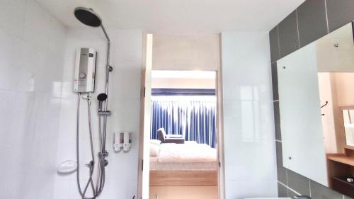 a bathroom with a shower and a bedroom at Family House Casa Seaside Rayong in Ban Chak Phai