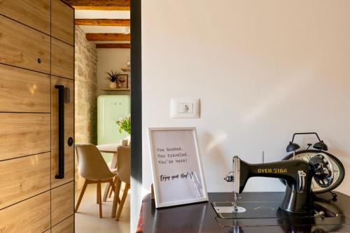a home office with a sewing machine on a desk at Apartment Vert San Zuian in Bale