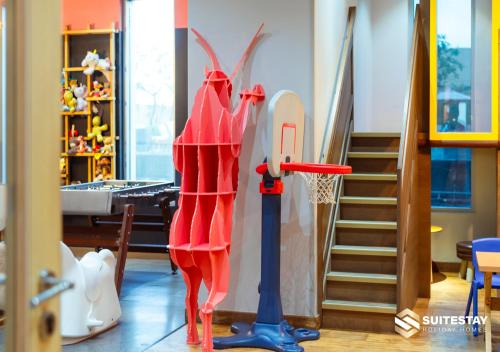 a living room with a basketball hoop and a staircase at Fashion Avenue Dubai Mall in Dubai