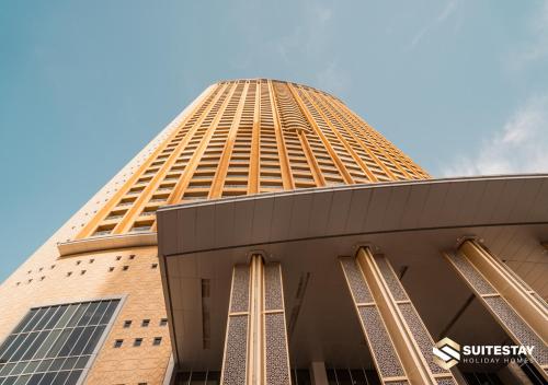 a tall building with a blue sky in the background at Fashion Avenue Dubai Mall in Dubai