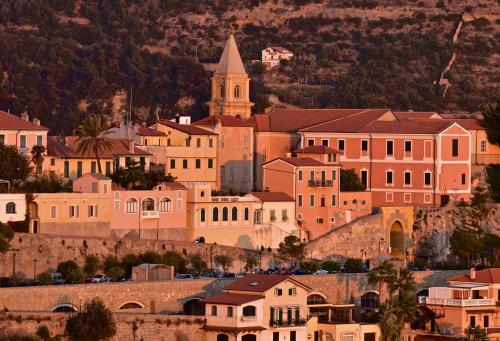 a town on top of a hill with a church at Alma Home Experience in Ventimiglia