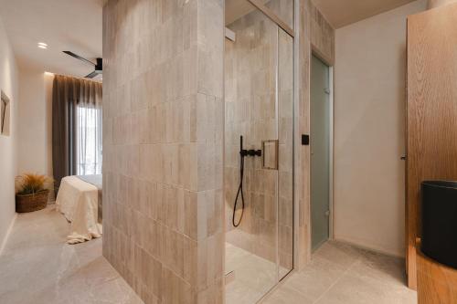 a shower with a glass door in a bathroom at Emery Hotel in Naxos Chora