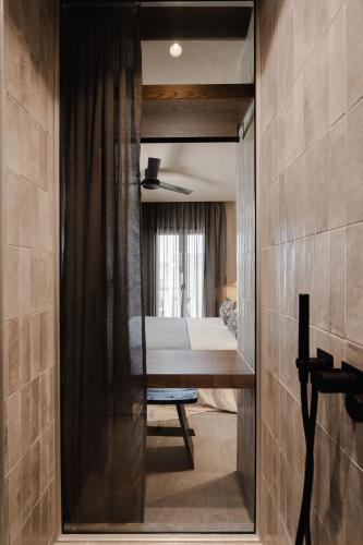 a view of a bedroom through a doorway at Emery Hotel in Naxos Chora