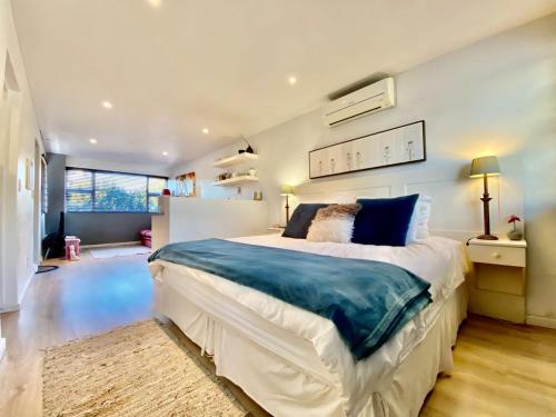 a large bedroom with a large bed in a room at Cape Nelson Guest House in Cape Town