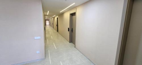an empty hallway with a door in a building at Hotel Pojata in Gjilan