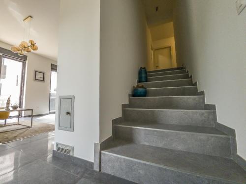 a concrete staircase in a house with a hallway at Apartman Dalmatino in Petrcane