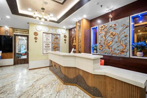 a restaurant lobby with a counter and a painting on the wall at PRIME LAND in Varanasi
