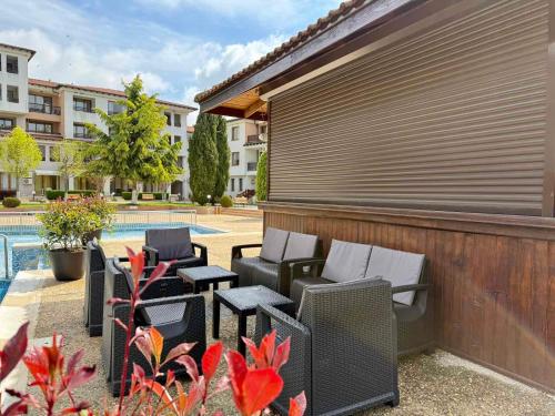 a group of chairs and tables next to a pool at Apartment C51 in Rogachevo