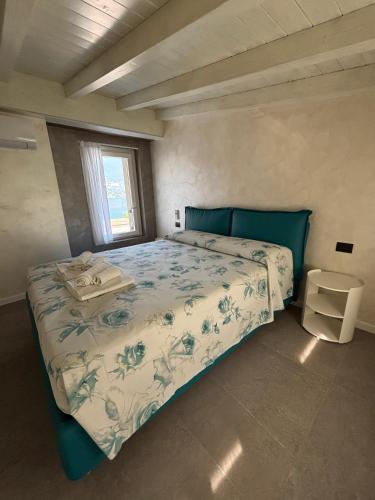 a bedroom with a bed with a blue head board at Villa Orchidea in Onno