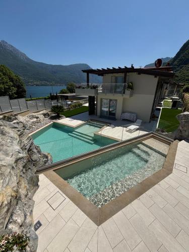 a house with a swimming pool and a house at Villa Orchidea in Onno
