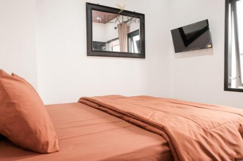 Postel nebo postele na pokoji v ubytování Limaran Syariah Nexura Collection