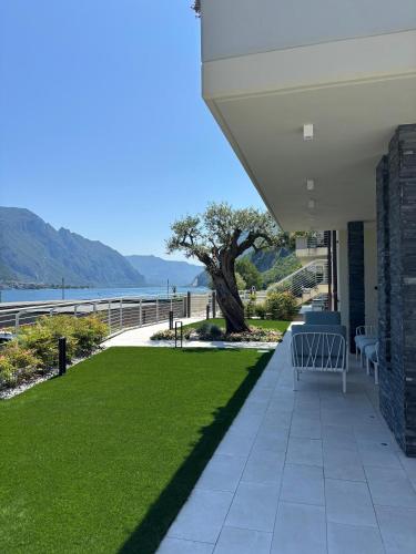 a patio with grass and a view of the water at Villa Orchidea in Onno