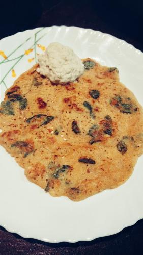 a white plate with a piece of food on it at Vyugen Villa #01 in Kāraikkudi