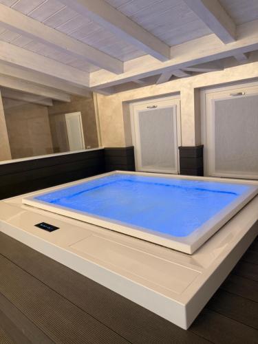 a large blue hot tub in a room at Villa Orchidea in Onno