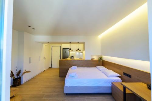a large room with a bed and a kitchen at Anna's Lovely Corfu Studio in Corfu